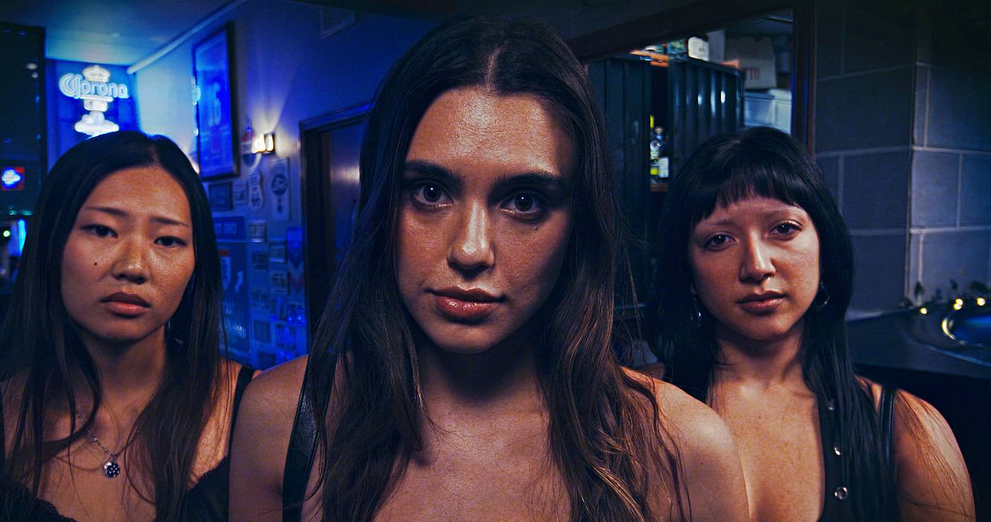 Three faces from the film dissolving one into the next: three young women in a neon lit bar, a young man in a checkered bucket hat, an older bearded man under a tree. The sequence settles on a young man in profile, almost entirely in shadow, against a window covered by a sheer curtain.